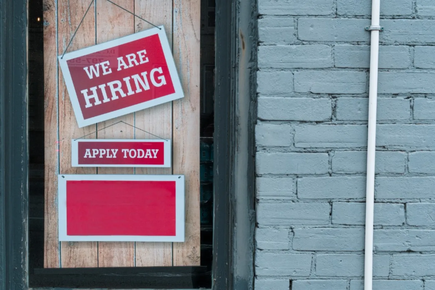 We Are Hiring sign in a shop window